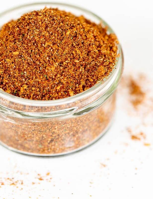 A clear glass jar filled with homemade elote seasoning.