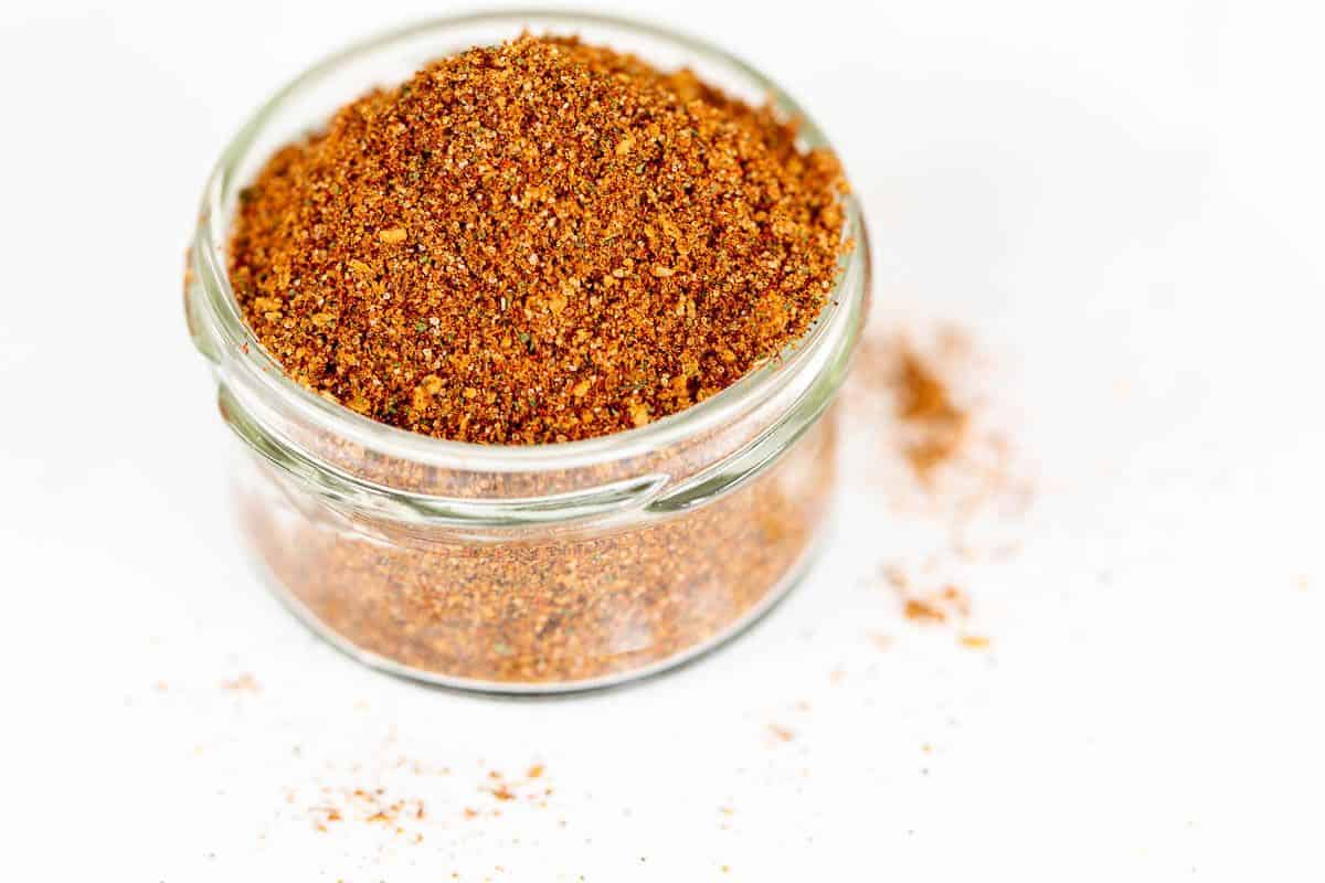 A clear glass jar filled with homemade elote seasoning.
