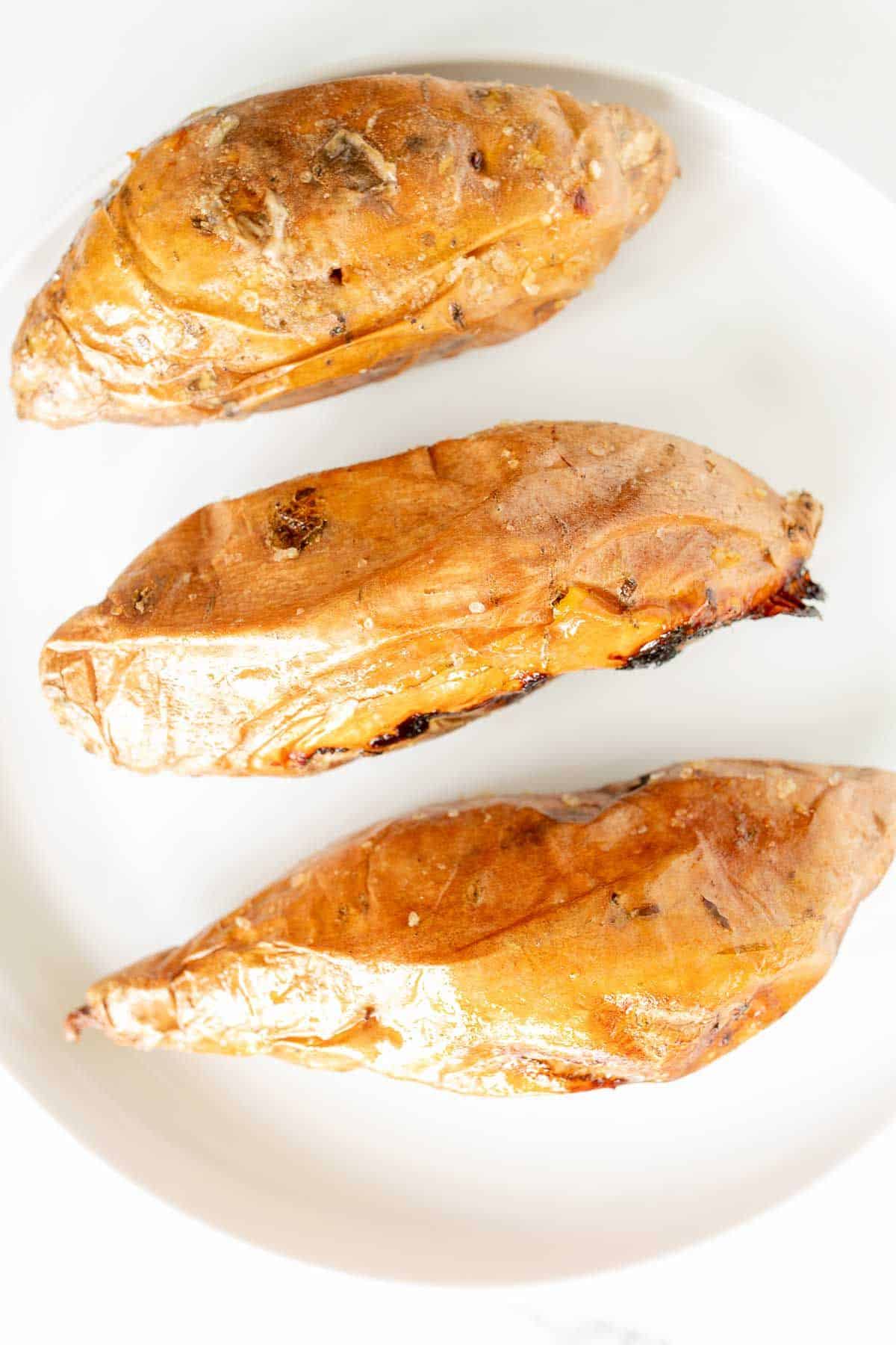 Grilled sweet potatoes on a white plate.