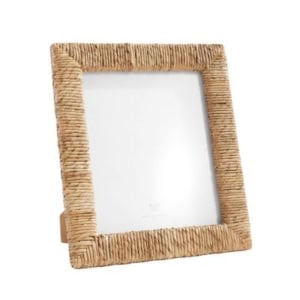 A rectangular picture frame with a textured, woven rattan design, perfect for standing upright on a flat surface or adding charm to your bookshelf decor.