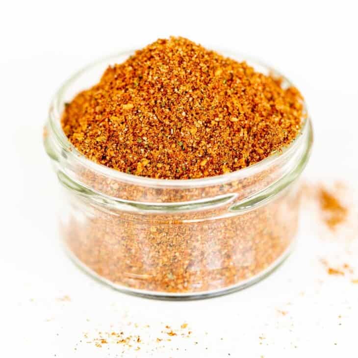 A clear glass jar filled with homemade elote seasoning.