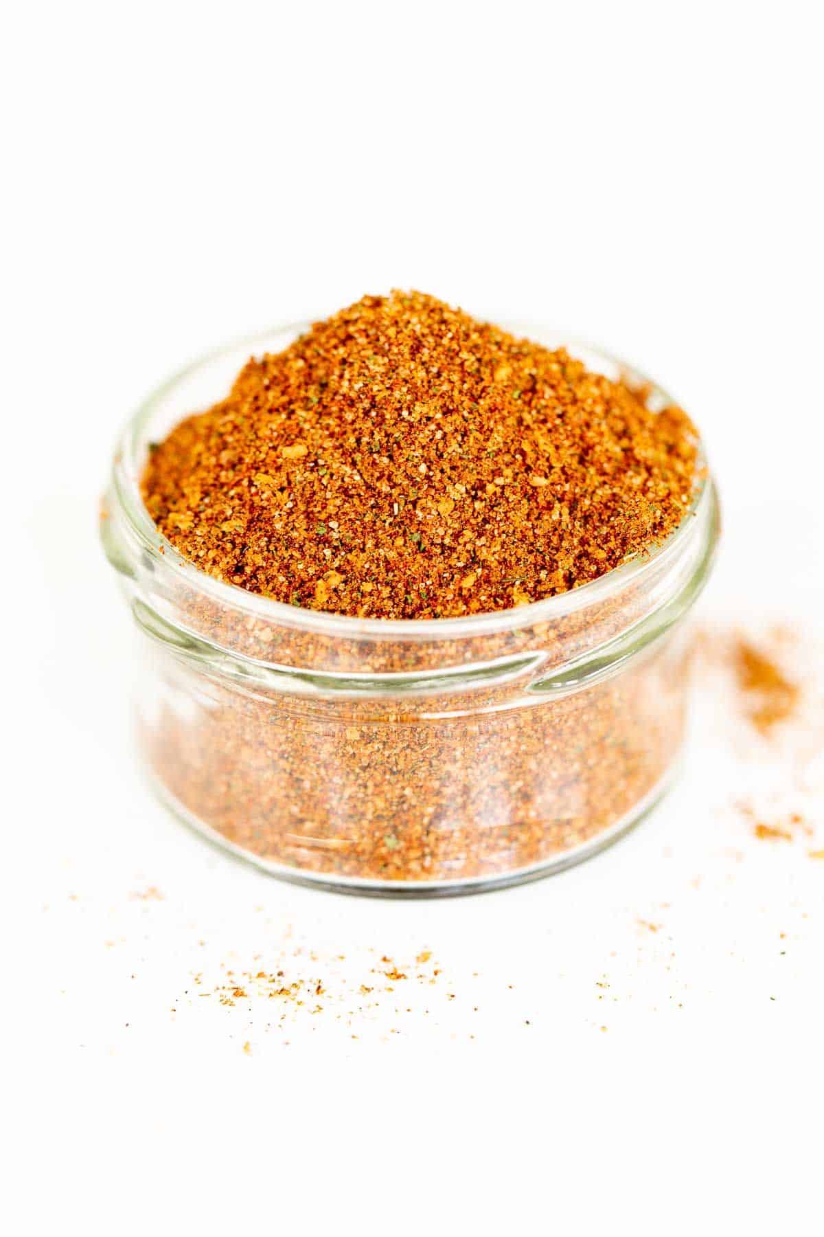 A clear glass jar filled with homemade elote seasoning.