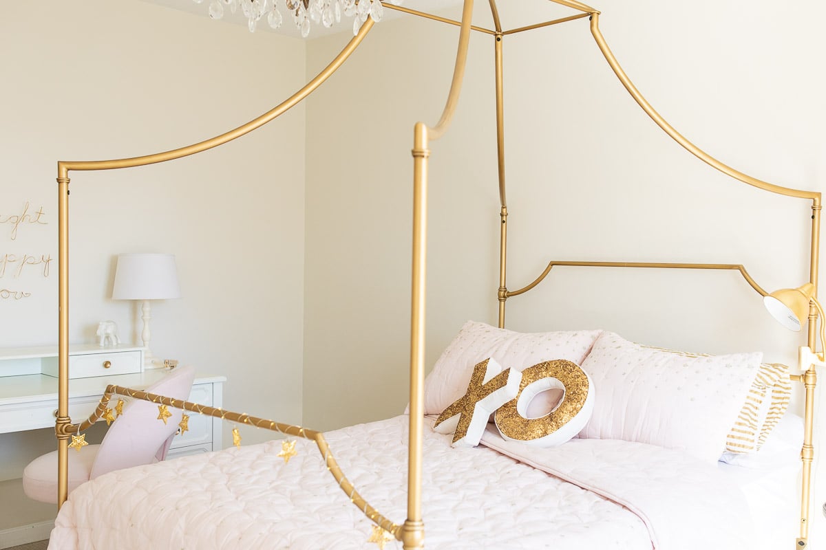 A gold canopy bed in a guide to luxury home decor for less