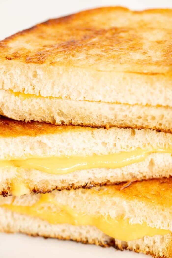 A stack of sliced mayo grilled cheese sandwiches