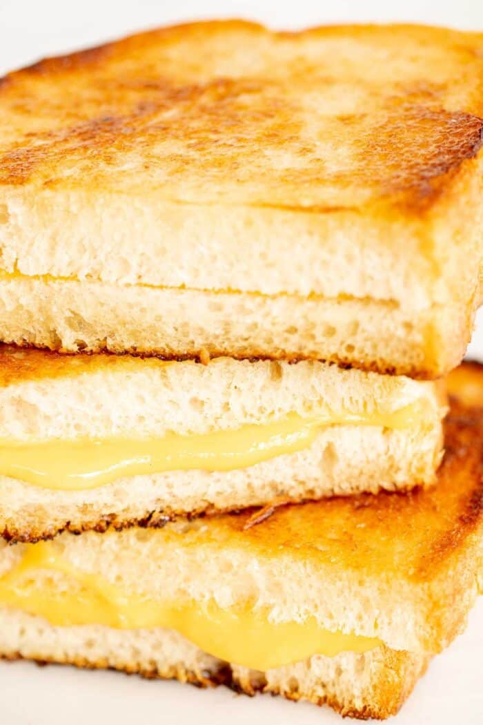 A stack of sliced mayo grilled cheese sandwiches