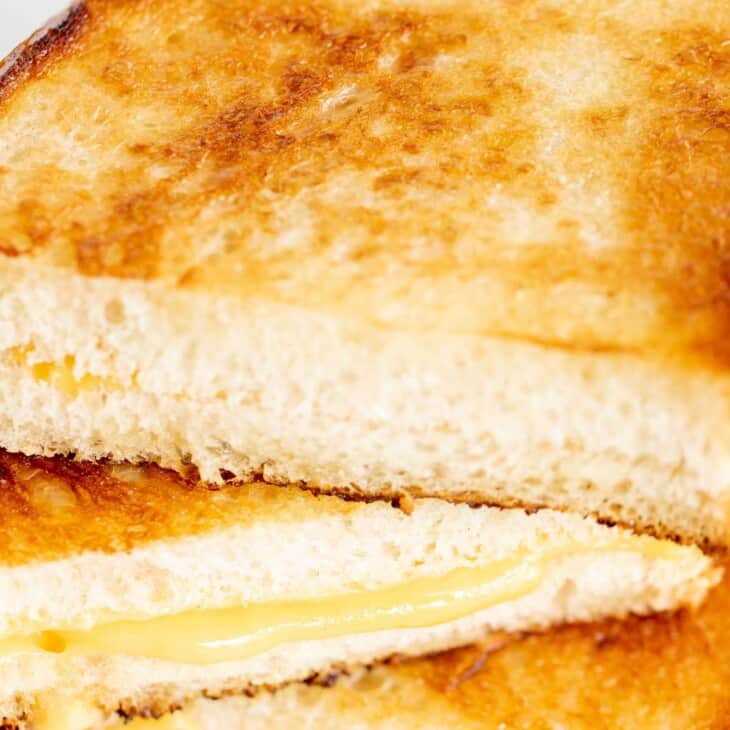 A stack of sliced mayo grilled cheese sandwiches