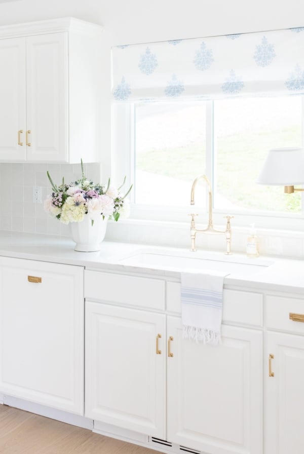 A white kitchen featuring white quartz countertops.