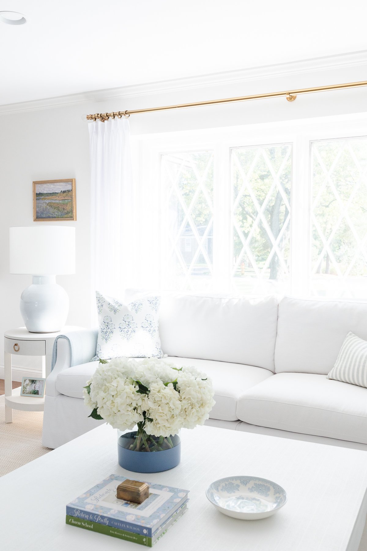 A white couch in a small living room, making the room look bigger.