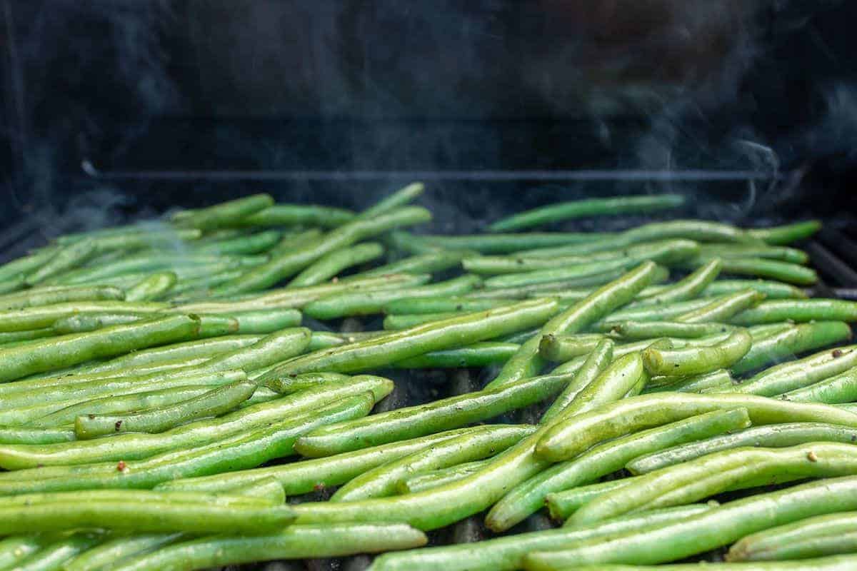 Fresh Green beans placed on a grill.