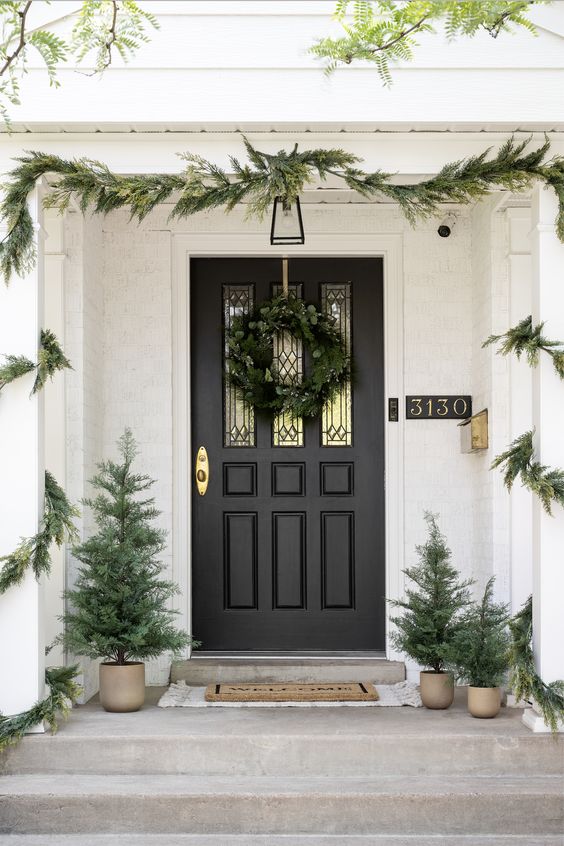 An entry decorated with Christmas decor from Studio McGee for Target