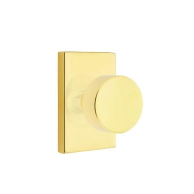 an unlacquered brass door knob on a white background.