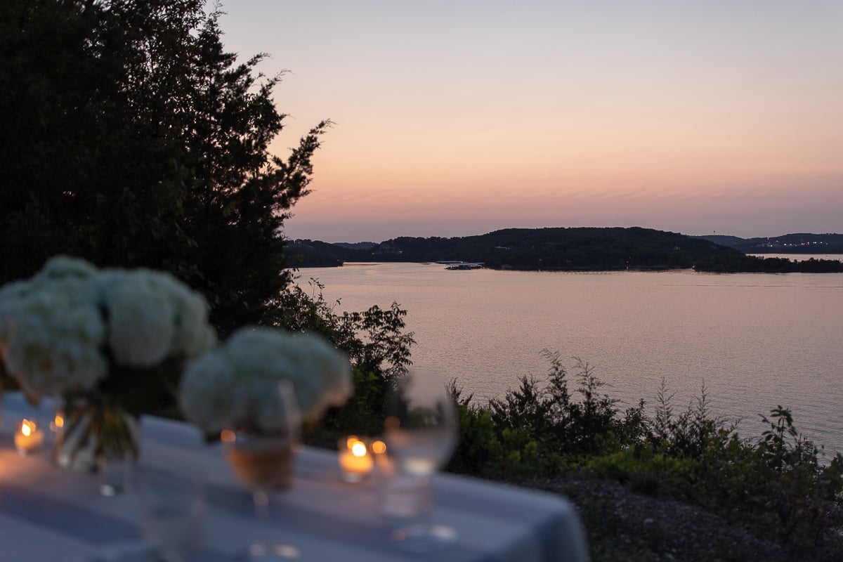 A table set up with bamboo dining chairs and water views for al fresco dining.