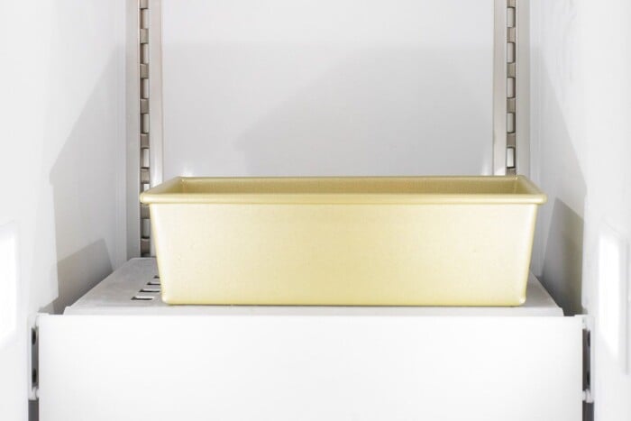a gold loaf pan inside a freezer