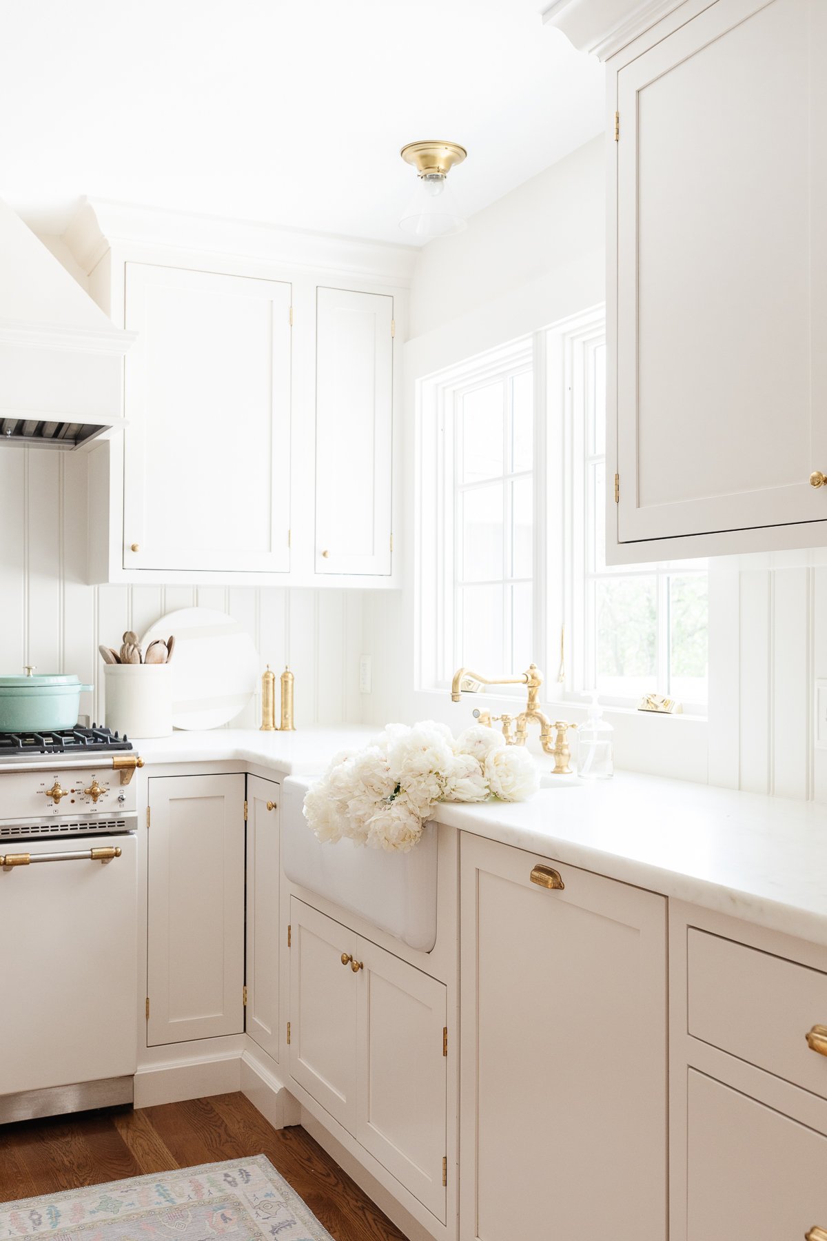 A cream kitchen with marble countertops with an eased edge.