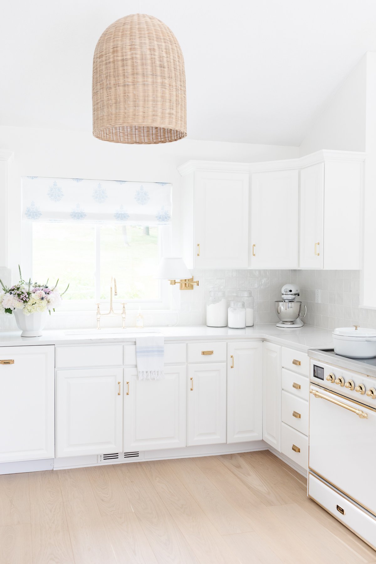 A white kitchen with white quartz countertops in a guide to countertop edges