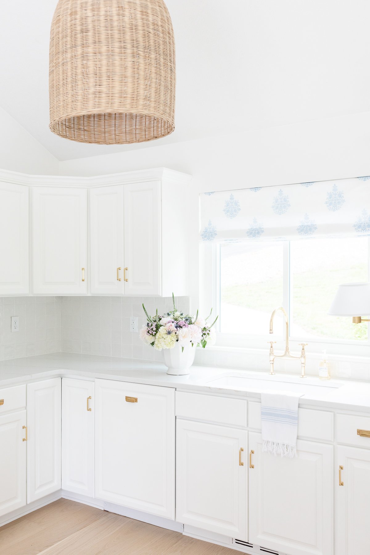A white kitchen with white quartz countertops in a guide to countertop edges