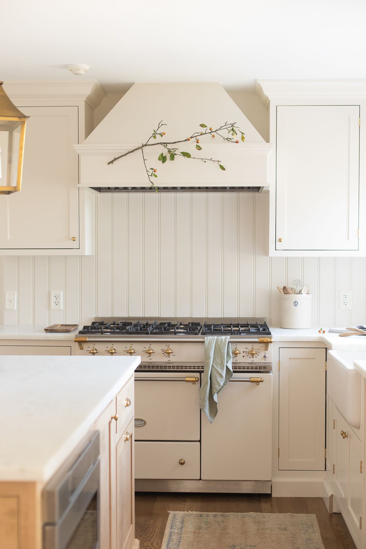 A cream kitchen with a french range and a drawer microwave in island