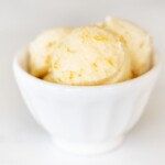 A white bowl filled with scoops of homemade orange butter.