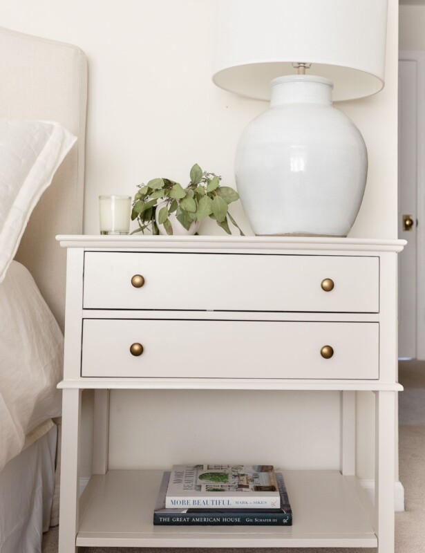 A nightstand in a cream bedroom, painted in Pale Oak Benjamin Moore paint color.