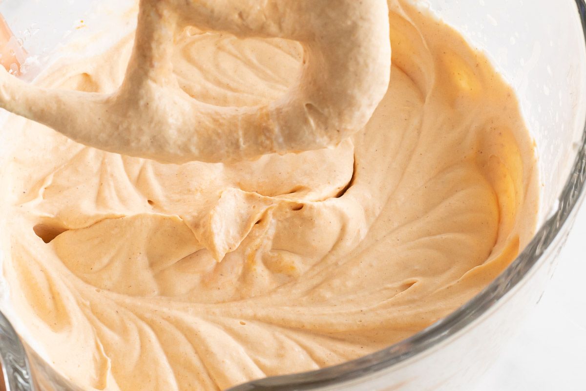 A mixture of no churn pumpkin cheesecake ice cream as it's blended.