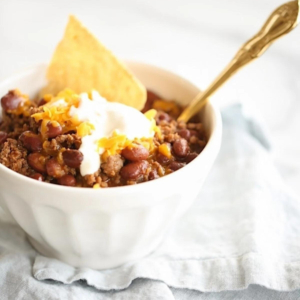 An easy chili recipe served with sour cream and tortilla chips.