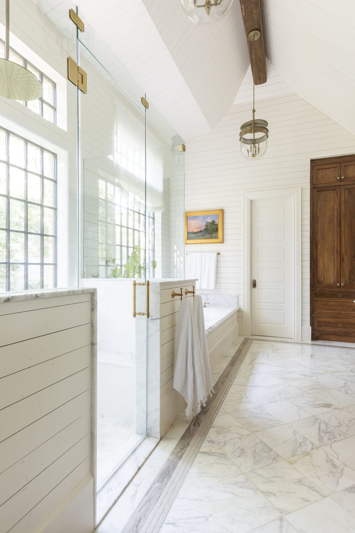 A primary bathroom with Cloud White walls and a wood door