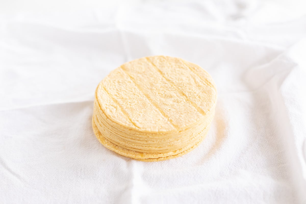 A stack of corn tortillas on a white surface