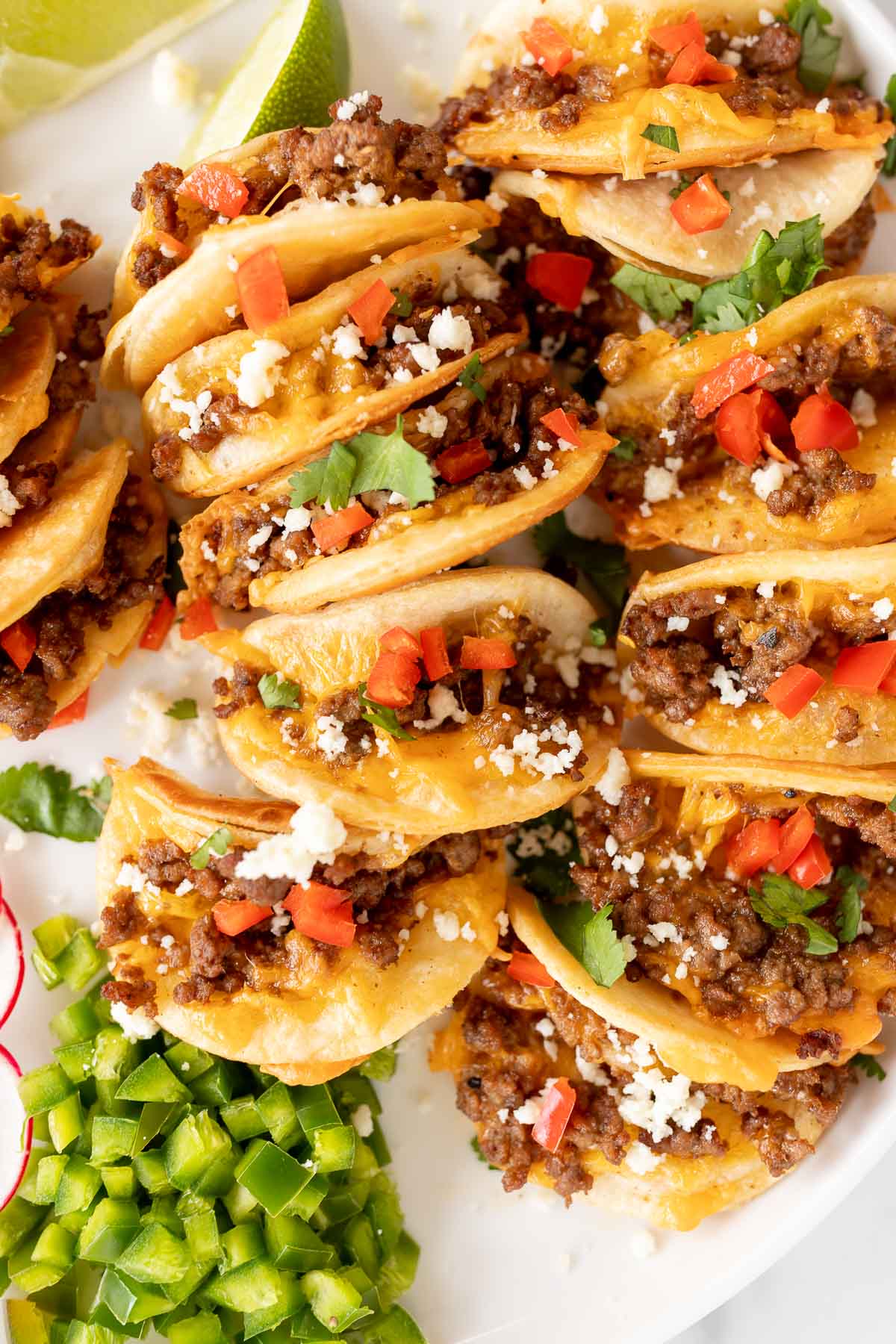 Beef mini tacos on a white platter.