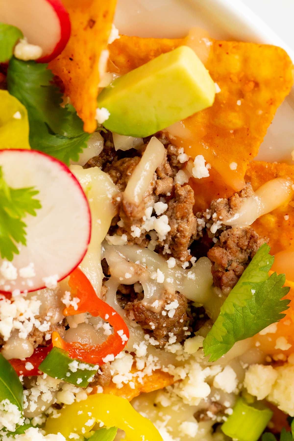 Close up shot of nachos with doritos loaded with toppings