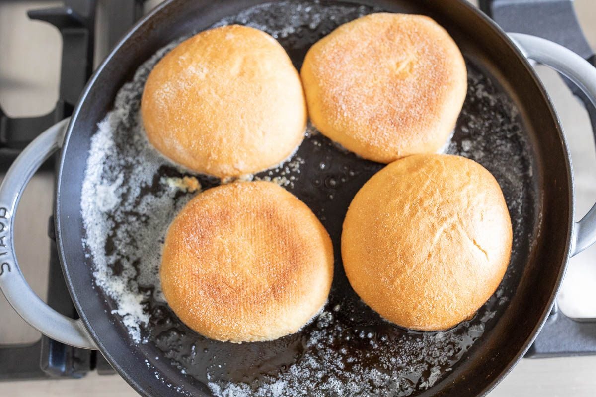 Toast burger buns in a cast iron skillet with melted butter