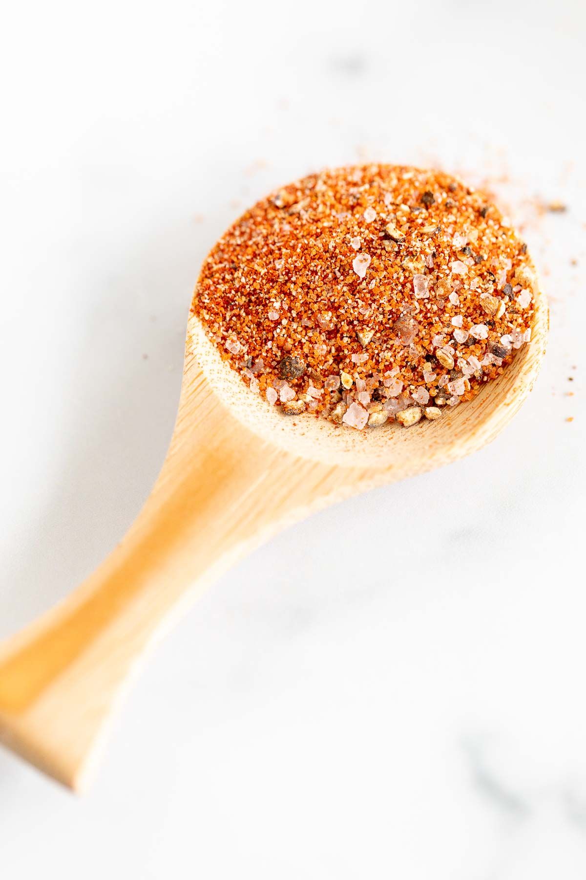 small wooden spoon full of the best burger seasoning