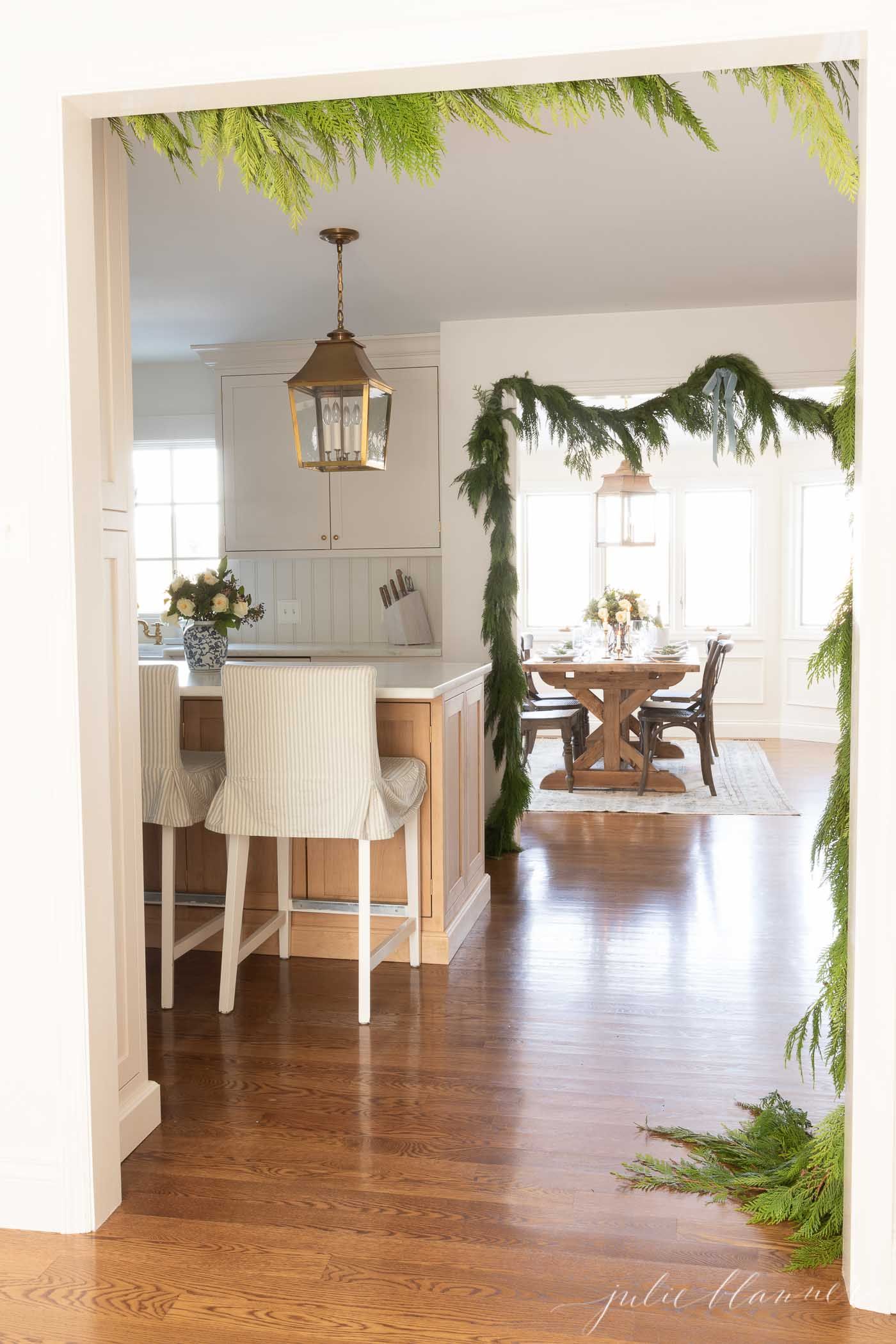 Fresh cedar wreath on the kitchen door, tied with a blue ribbon