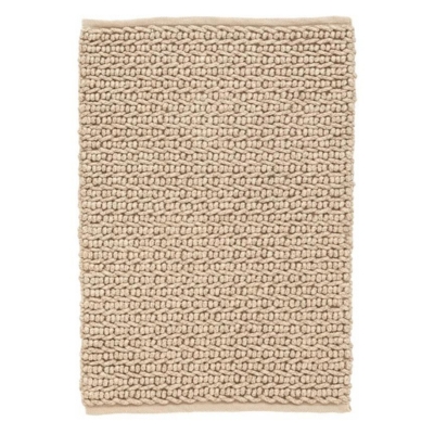 A neutral beige rug with a braided pattern.