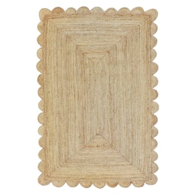 A natural jute rug with scalloped edges, perfect for adding a touch of elegance to any space.