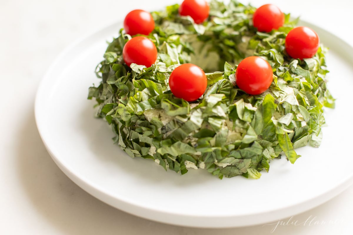 pesto cheeseball wreath on a white plate