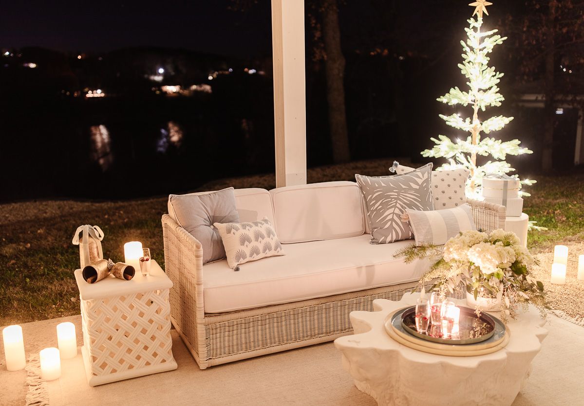 A patio with Serena and Lily patio furniture, dressed up for Christmas at night