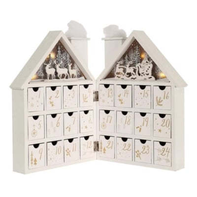 A wooden advent calendar featuring a house and deer designs.