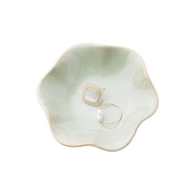 A pale green ceramic ring dish