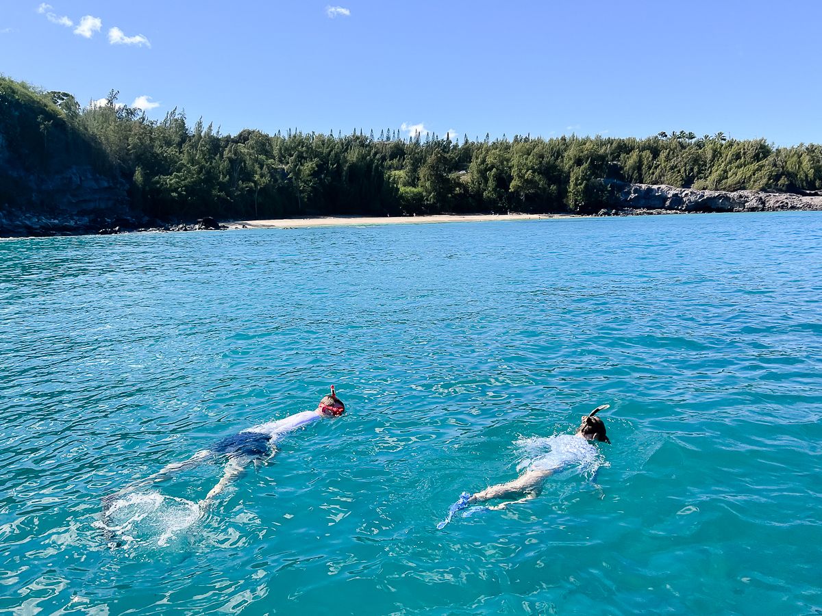 Little girls snorkeling in the water on Maui