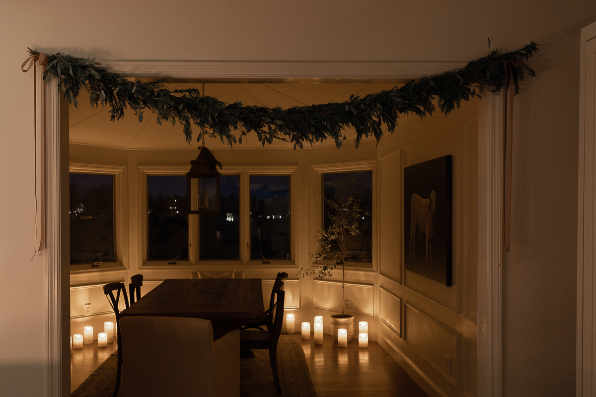 candle lit room with garland overhead