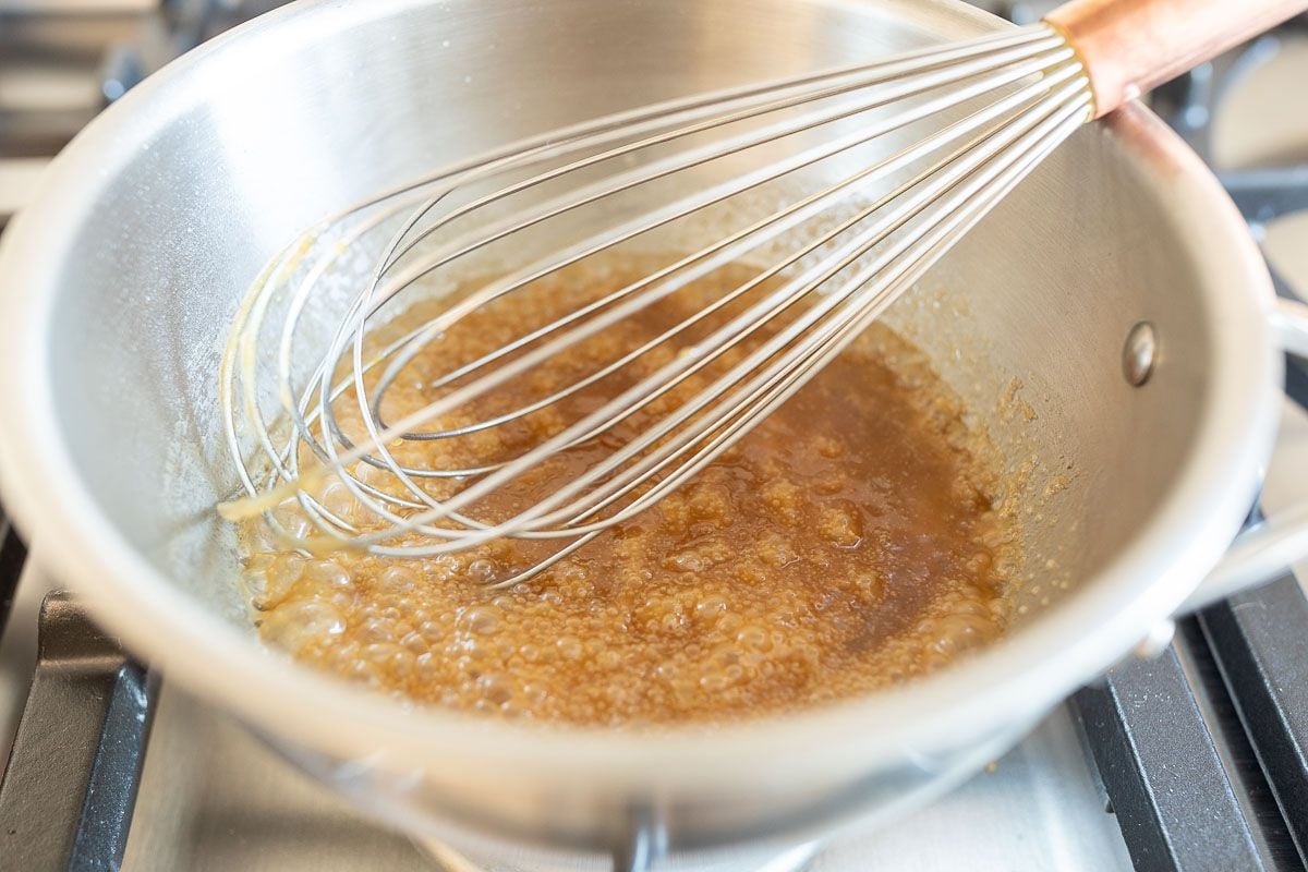 Caramel sauce in a pan with a whisk