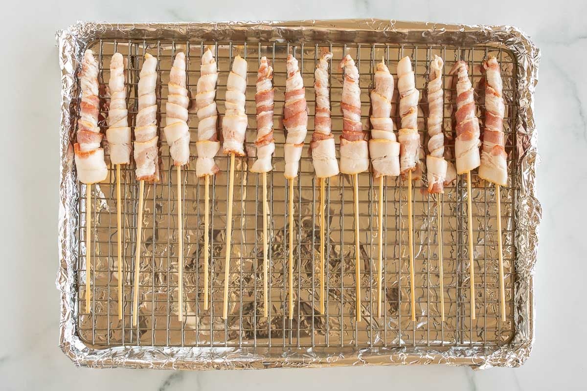 Caramel bacon on a skewer, laid out on a baking sheet