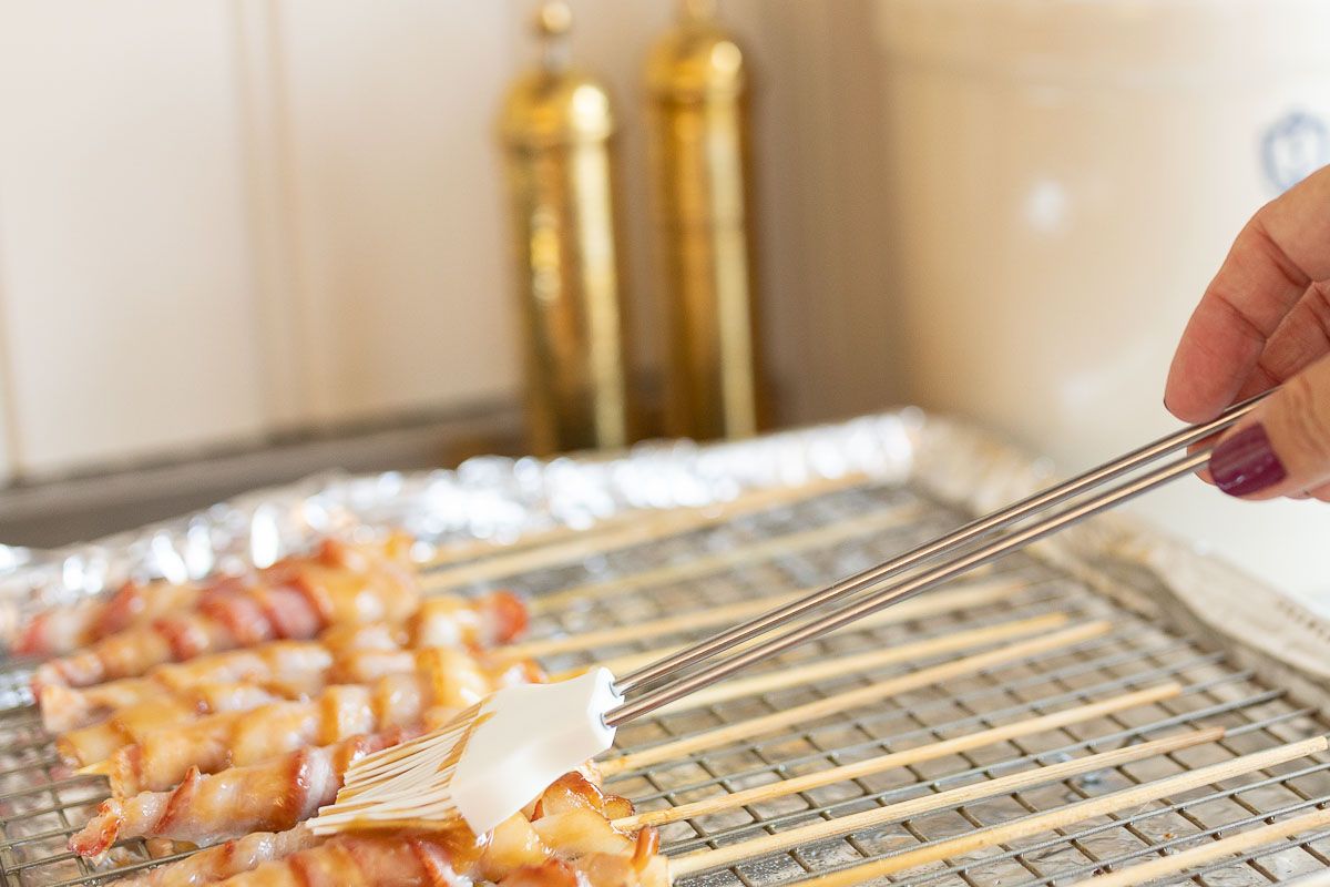 Caramel bacon on skewers, laid out on a baking sheet
