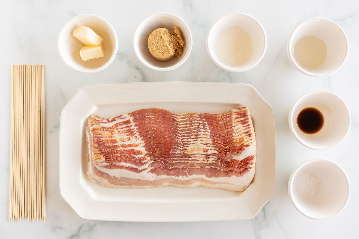 Bacon on a white plate, with ingredients for caramelizing