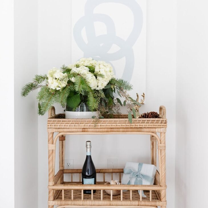 A rattan bar cart in the corner of a Chantilly White painted room