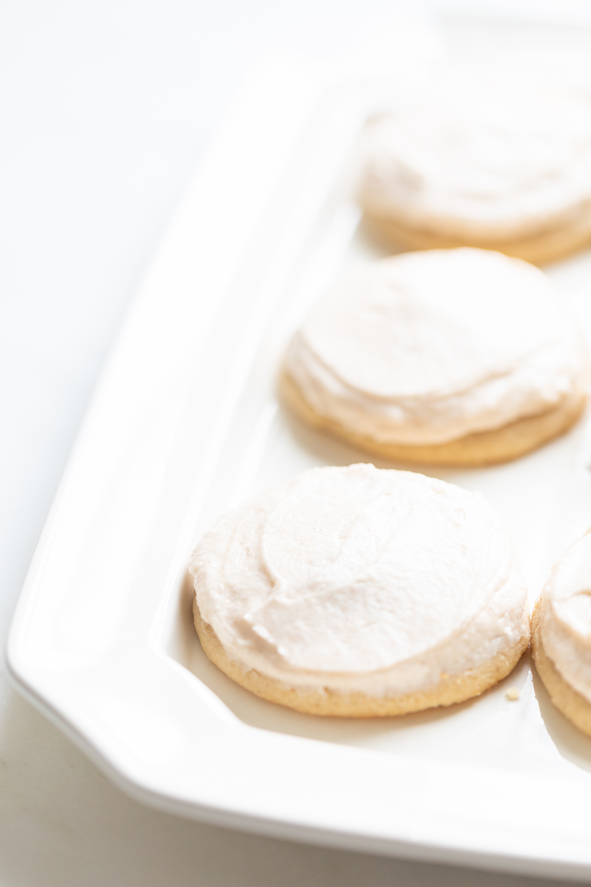 frosted cinnamon sugar cookies on a white platter