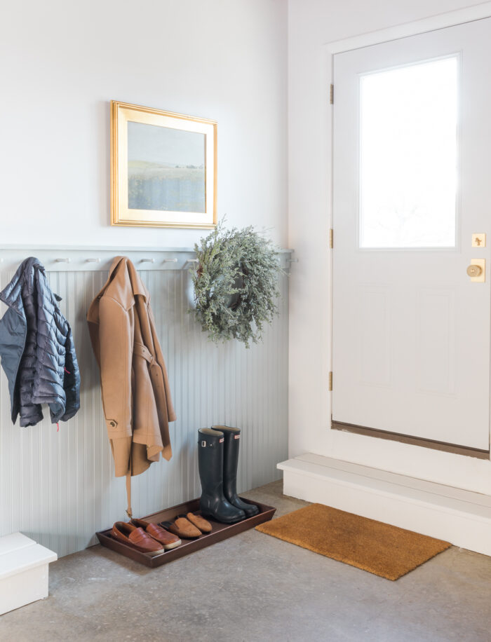 garage mudroom with boot tray and peg rail
