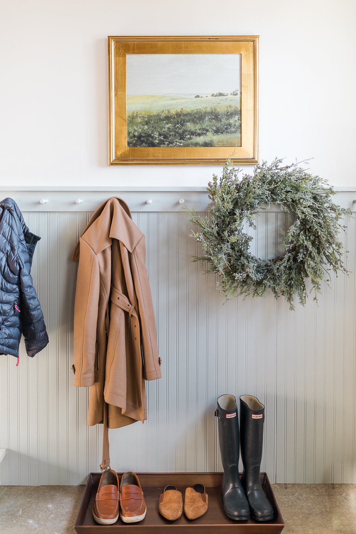 garage mudroom with art coats and boots