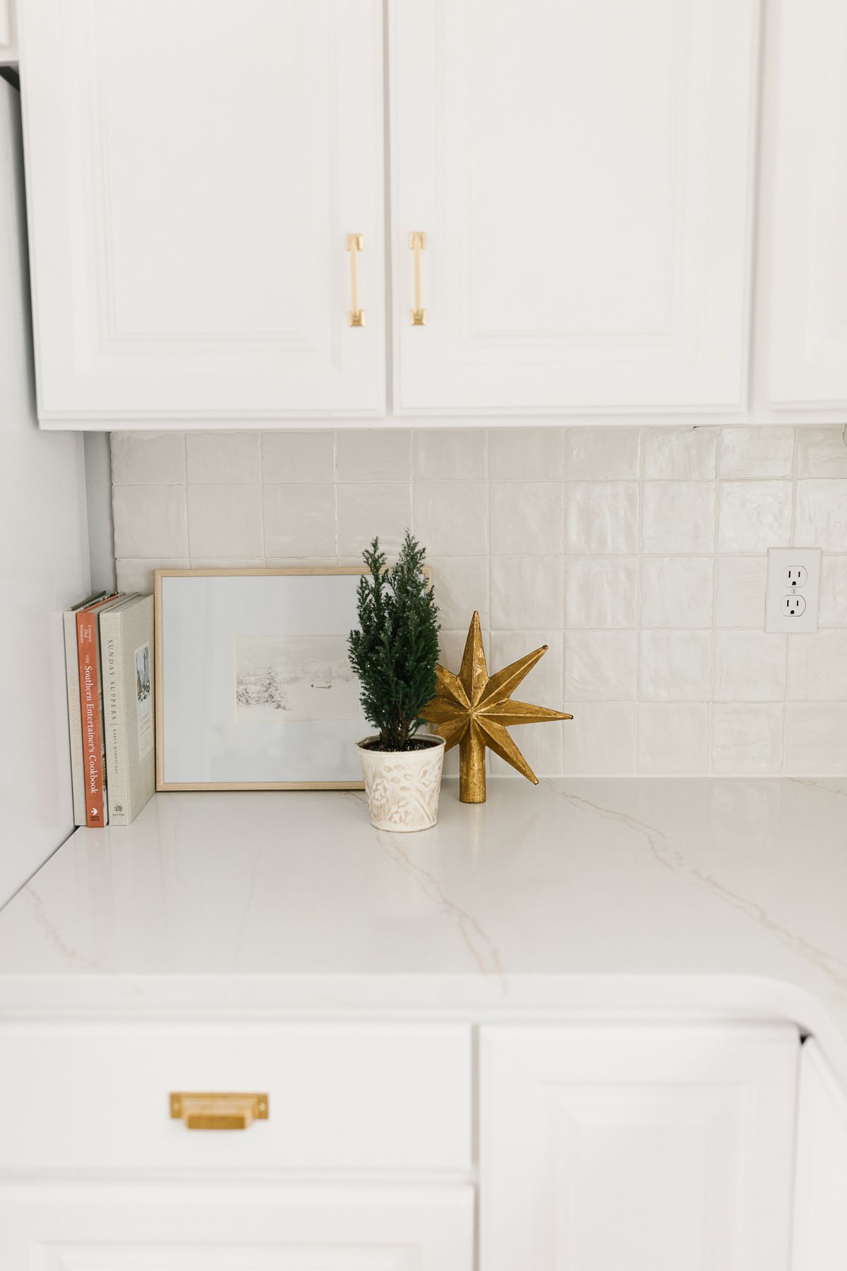 White kitchen cabinets with a white tile backsplash, with a white polyblend grout color