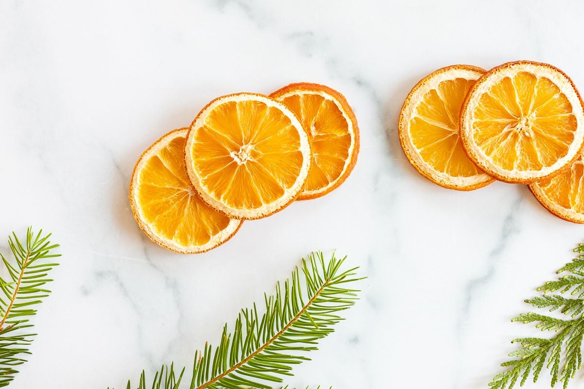 An orange garland laid out on a marble countertop